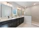 Bathroom with double vanity, quartz countertop and a tiled shower with glass door at 6525 Rover Way, St Cloud, FL 34771