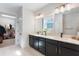 Bathroom with double vanity, quartz countertop and a walk-in closet at 6525 Rover Way, St Cloud, FL 34771