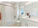 Modern bathroom featuring white tile, bathtub with shower, and vanity with sink at 6525 Rover Way, St Cloud, FL 34771
