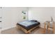 Simple bedroom design features a platform bed, side table, and a sunny window at 6525 Rover Way, St Cloud, FL 34771