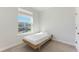 Bright bedroom showcases simple bed and large window, offering natural light at 6525 Rover Way, St Cloud, FL 34771