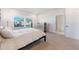 Cozy bedroom with large window, light carpet and a four-poster bed at 6525 Rover Way, St Cloud, FL 34771