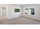 Cozy bedroom features carpet, two windows, and mounted TV for relaxing space at 6525 Rover Way, St Cloud, FL 34771