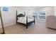 Bedroom with a four poster bed, light carpet and a window with view at 6525 Rover Way, St Cloud, FL 34771