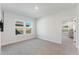 Bright bedroom with neutral carpet, two windows, and an adjacent room view at 6525 Rover Way, St Cloud, FL 34771