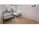 Bright bedroom featuring two twin beds, hardwood floors, and a sunlit window at 6525 Rover Way, St Cloud, FL 34771