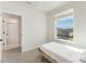 Well-lit bedroom with a simple bed, window view, and access to a bathroom at 6525 Rover Way, St Cloud, FL 34771