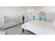 Well lit bedroom with light carpet, four-poster bed, and a walk-in closet at 6525 Rover Way, St Cloud, FL 34771