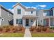 Charming white two-story home with a welcoming front porch and well-maintained landscaping at 6525 Rover Way, St Cloud, FL 34771