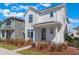 Stylish two-story home boasting a white exterior and neatly landscaped front yard at 6525 Rover Way, St Cloud, FL 34771