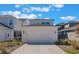 Two car garage with ample parking surrounded by desert landscaping at 6525 Rover Way, St Cloud, FL 34771