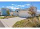 Three car garage with ample parking surrounded by desert landscaping at 6525 Rover Way, St Cloud, FL 34771