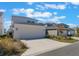 Two car garage with ample parking surrounded by desert landscaping at 6525 Rover Way, St Cloud, FL 34771
