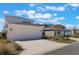 Modern two car garage with large driveways in a residential neighborhood at 6525 Rover Way, St Cloud, FL 34771