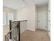 Carpeted upstairs hallway with dark wood banister and multiple access doors at 6525 Rover Way, St Cloud, FL 34771