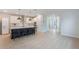 Modern kitchen featuring white cabinets, stainless steel appliances, and a large island with seating at 6525 Rover Way, St Cloud, FL 34771