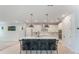 Bright kitchen with an island, stylish pendant lights, white cabinetry, and a retro Smeg refrigerator at 6525 Rover Way, St Cloud, FL 34771