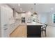 Contemporary kitchen with sleek white cabinets, stainless steel appliances, and an island at 6525 Rover Way, St Cloud, FL 34771