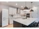 Stylish kitchen with modern appliances, an island, and white herringbone tile backsplash at 6525 Rover Way, St Cloud, FL 34771
