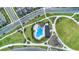 Aerial view of community pool and playground showing meandering sidewalks and neighborhood streets at 6525 Rover Way, St Cloud, FL 34771