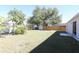 Spacious backyard featuring lush green grass and mature trees at 7 Sequoia Way, Kissimmee, FL 34758
