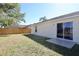 View of backyard patio, exterior of home, and wood fence at 7 Sequoia Way, Kissimmee, FL 34758