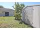 Backyard with shed, mature trees, and sliding glass door at 7 Sequoia Way, Kissimmee, FL 34758