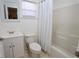 Bright bathroom features a shower-tub combo, white vanity, and neutral tile flooring at 7 Sequoia Way, Kissimmee, FL 34758