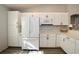 Bright kitchen featuring white cabinets, modern appliances, and ample counter space at 7 Sequoia Way, Kissimmee, FL 34758