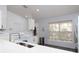 The well-lit kitchen offers stone countertops, white cabinetry and new appliances at 7 Sequoia Way, Kissimmee, FL 34758