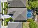 Aerial view of house with a screened-in backyard pool, patio and beautiful landscaping at 7945 Pleasant Pine Cir, Winter Park, FL 32792