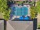 Aerial view of a screened-in backyard pool with sun umbrellas and lush landscaping at 7945 Pleasant Pine Cir, Winter Park, FL 32792