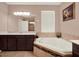 Elegant bathroom with a corner bathtub, dual vanities, and natural light at 7945 Pleasant Pine Cir, Winter Park, FL 32792