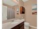 Bathroom features a vanity sink, toilet, and enclosed shower with a curtain at 7945 Pleasant Pine Cir, Winter Park, FL 32792
