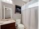 Bathroom features a vanity sink, toilet, and enclosed shower with a curtain at 7945 Pleasant Pine Cir, Winter Park, FL 32792