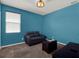 Bedroom with a blue wall, a gray leather couch and a window at 7945 Pleasant Pine Cir, Winter Park, FL 32792