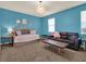 bedroom with blue walls, daybed, and black leather couch at 7945 Pleasant Pine Cir, Winter Park, FL 32792