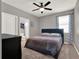 Cozy bedroom with a ceiling fan, and a bed with a blue headboard at 7945 Pleasant Pine Cir, Winter Park, FL 32792
