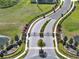 Grand entrance to the community with beautifully landscaped grounds, a security gate, and a serene pond at 7945 Pleasant Pine Cir, Winter Park, FL 32792