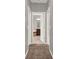 Hallway between rooms with brown carpet, leading into bathroom at 7945 Pleasant Pine Cir, Winter Park, FL 32792