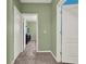 Hallway between rooms with brown carpet, leading into bedroom at 7945 Pleasant Pine Cir, Winter Park, FL 32792