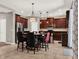 Eat-in kitchen features stainless appliances, dark wood cabinets and a tile floor at 7945 Pleasant Pine Cir, Winter Park, FL 32792