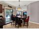 Open kitchen with an island, dark cabinets, granite countertops, and easy access to the pool area at 7945 Pleasant Pine Cir, Winter Park, FL 32792