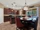 Modern kitchen with dark wood cabinets, granite countertops, an island, and pool view at 7945 Pleasant Pine Cir, Winter Park, FL 32792