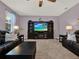 Living room with plush carpet and entertainment center at 7945 Pleasant Pine Cir, Winter Park, FL 32792