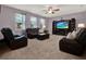 Spacious living room with plush carpeting, ceiling fan, and large windows at 7945 Pleasant Pine Cir, Winter Park, FL 32792