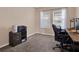 Functional office space with a desk, storage, and natural light from two windows at 7945 Pleasant Pine Cir, Winter Park, FL 32792