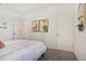 Clean bedroom featuring all-white walls, simple art, and plush carpeting at 866 Pebble Crest Ln, Eagle Lake, FL 33839