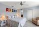 Well-lit bedroom featuring a cozy armchair, closet, and serene atmosphere at 8963 Majesty Palm Rd, Kissimmee, FL 34747