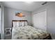 Cozy bedroom featuring a queen-sized bed with a palm-themed comforter and a closet with sliding doors at 8963 Majesty Palm Rd, Kissimmee, FL 34747